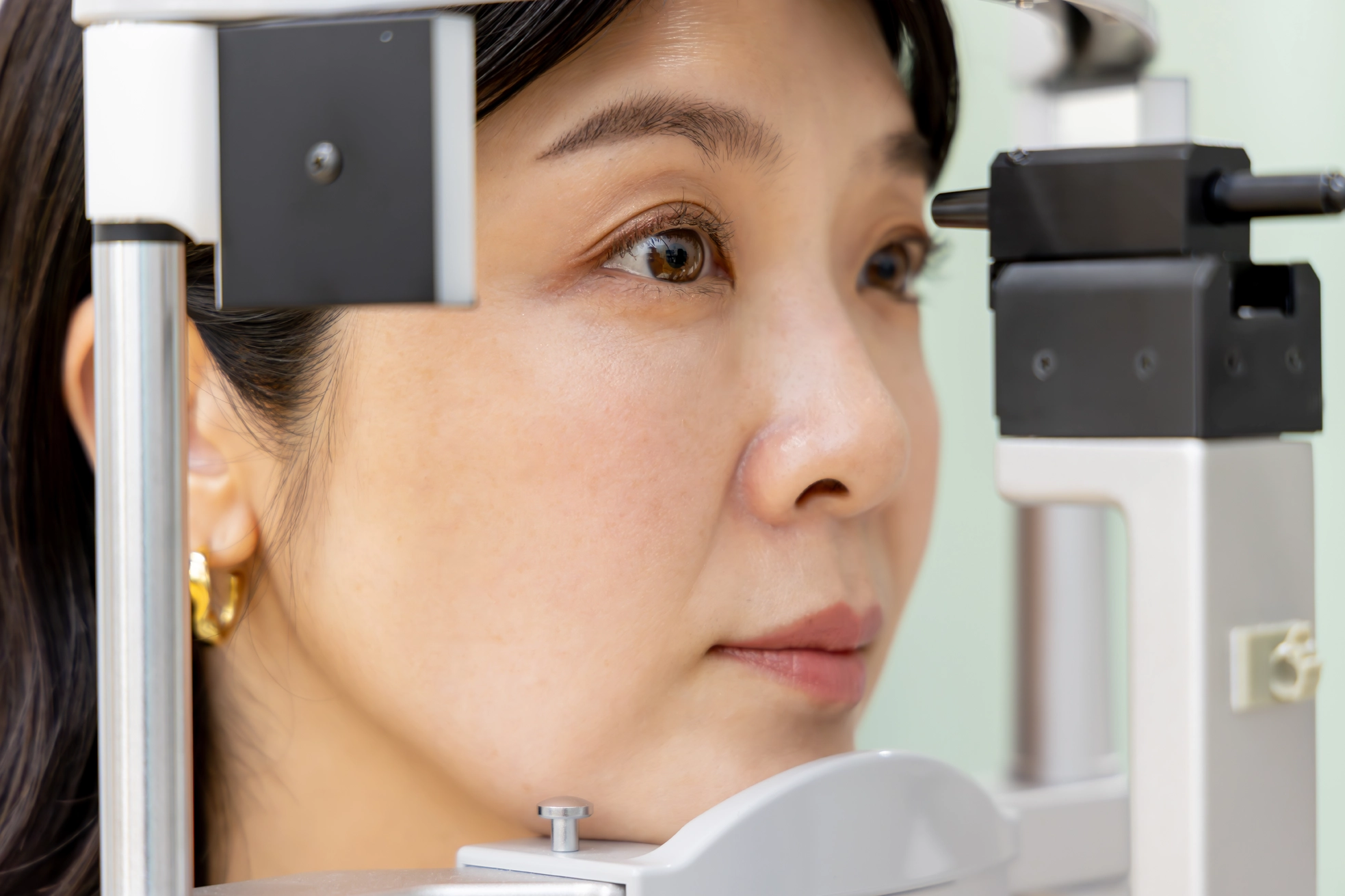 A woman receiving an eye test at an ophthalmology clinic